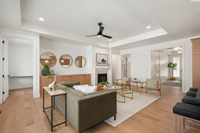 670 Cortona Unit 39, Richland, WA 99352 - living area featuring a tray ceiling, ceiling fan, a glass covered fireplace, light wood-type flooring, and recessed lighting