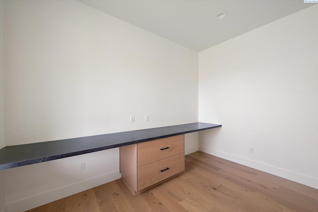 670 Cortona Unit 39, Richland, WA 99352 - unfurnished office featuring built in desk, baseboards, and light wood-style flooring