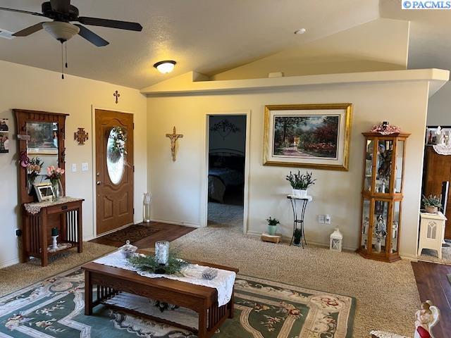 carpeted living room featuring lofted ceiling and ceiling fan