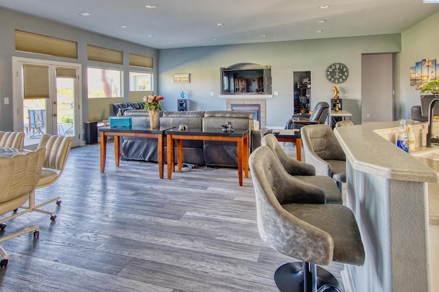 living room with hardwood / wood-style flooring and a tile fireplace