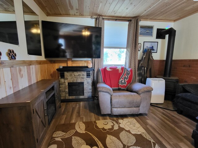 132 2nd St, Diamond, WA 99111 - living area with wood ceiling, wainscoting, wood finished floors, a wood stove, and wooden walls