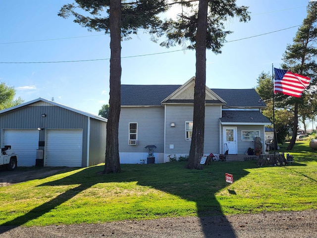 132 2nd St, Diamond, WA 99111 - view of front of home featuring a front yard, an outdoor structure, a garage, and a shingled roof