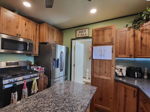 132 2nd St, Diamond, WA 99111 - kitchen with stainless steel appliances, recessed lighting, dark stone counters, and brown cabinets