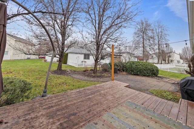 wooden terrace featuring a lawn