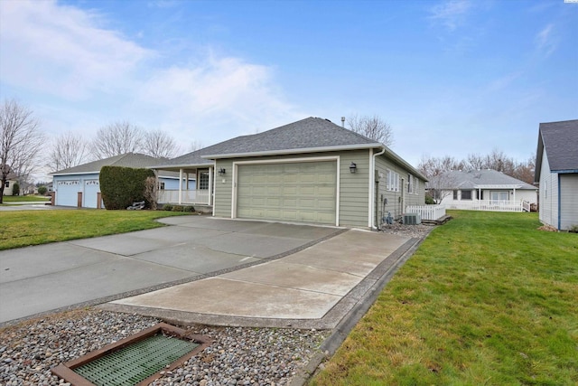 view of front of home with a garage, covered porch, a front lawn, and central air condition unit