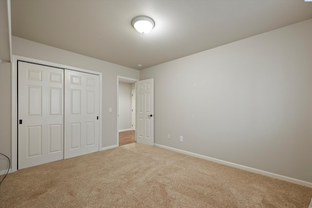 unfurnished bedroom featuring carpet floors and a closet