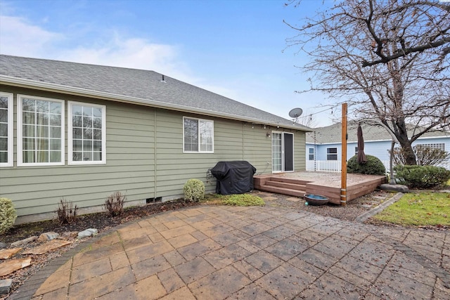 back of property featuring a patio and a deck