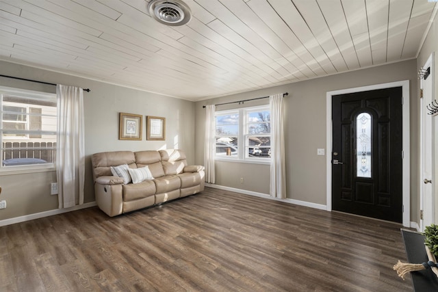 living area with crown molding, visible vents, wood finished floors, wooden ceiling, and baseboards