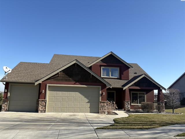 craftsman-style home featuring a garage, stone siding, a front lawn, and concrete driveway