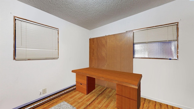 1735 NE Wheatland Dr, Pullman, WA 99163 - home office with baseboards, light wood finished floors, and a textured ceiling