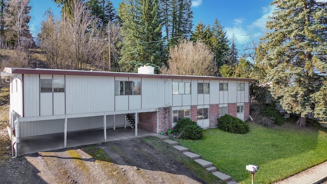 1735 NE Wheatland Dr, Pullman, WA 99163 - view of front facade featuring brick siding, a chimney, and a front yard