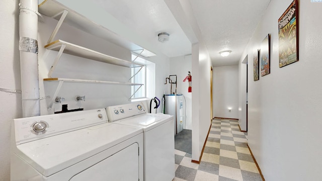 1735 NE Wheatland Dr, Pullman, WA 99163 - laundry area featuring light floors, laundry area, separate washer and dryer, water heater, and a textured ceiling