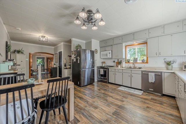 805 Babs Ave, Benton City, WA 99320 - kitchen with appliances with stainless steel finishes, a sink, arched walkways, a chandelier, and light countertops