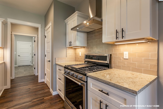 2989 Wild Canyon Way, Richland, WA 99354 - kitchen featuring tasteful backsplash, white cabinets, stainless steel range with gas stovetop, light stone counters, and wall chimney range hood