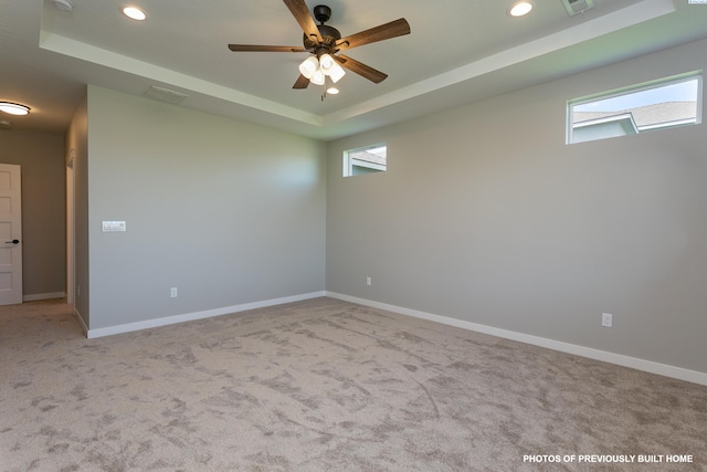 2989 Wild Canyon Way, Richland, WA 99354 - carpeted spare room featuring a healthy amount of sunlight, ceiling fan, and a tray ceiling