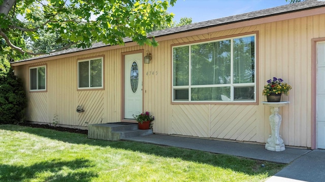 4745 W Robin Ct, West Richland, WA 99353 - doorway to property featuring a lawn and a shingled roof