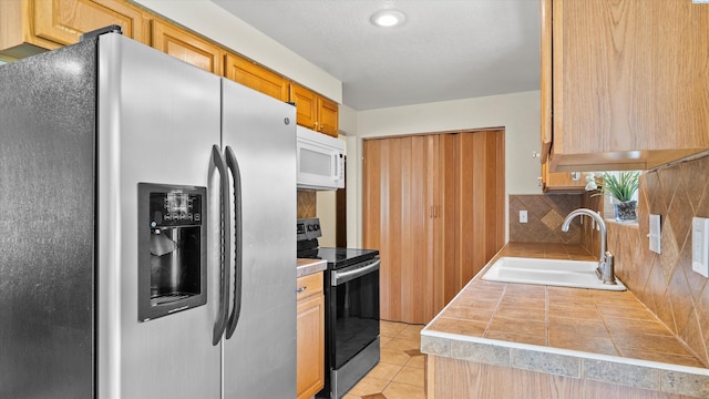 4745 W Robin Ct, West Richland, WA 99353 - kitchen featuring appliances with stainless steel finishes, light tile patterned flooring, and tile counters
