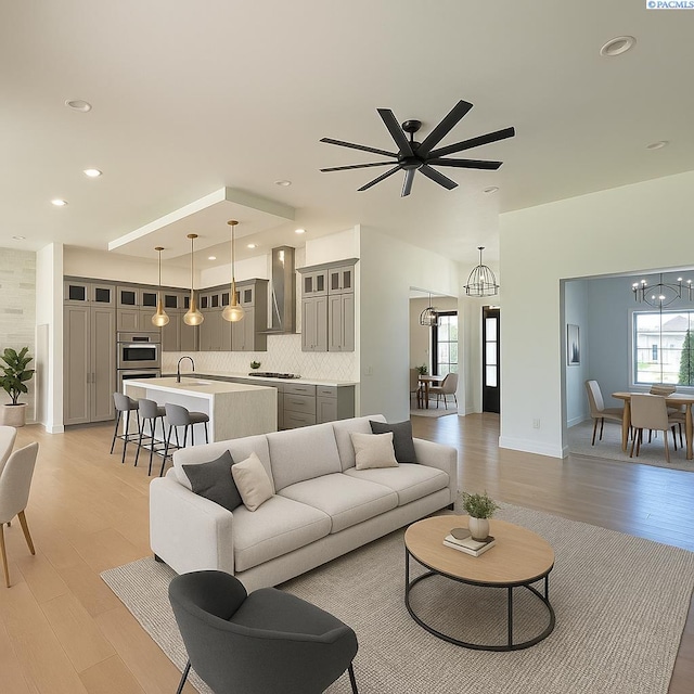 3408 Royce Ln, Pasco, WA 99301 - living room featuring a chandelier, light wood-style flooring, and ceiling fan