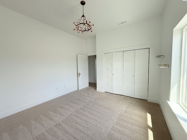 3408 Royce Ln, Pasco, WA 99301 - unfurnished bedroom featuring a chandelier, carpet flooring, and a closet