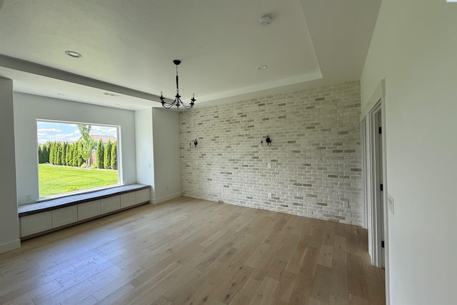 3408 Royce Ln, Pasco, WA 99301 - unfurnished room with a chandelier, brick wall, light wood-style floors, and a smoke detector