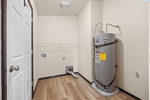 laundry area with laundry area, light wood finished floors, water heater, and hookup for an electric dryer
