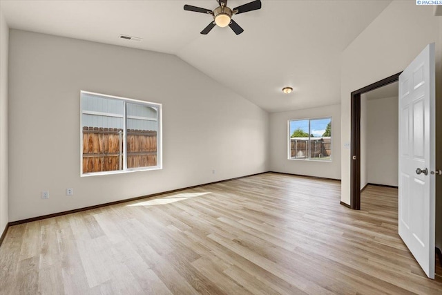 unfurnished bedroom with baseboards, visible vents, light wood-style flooring, and vaulted ceiling