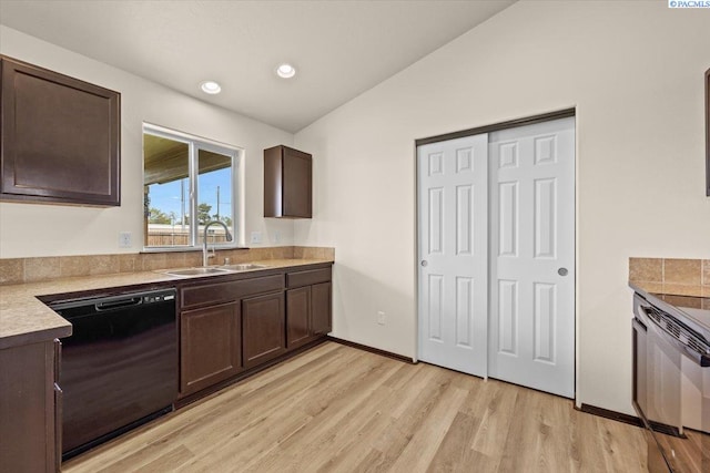 kitchen with dark brown cabinets, a sink, light countertops, light wood-style flooring, and black dishwasher