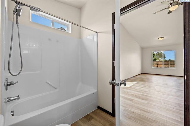 full bathroom featuring shower / bath combination, baseboards, ceiling fan, and wood finished floors