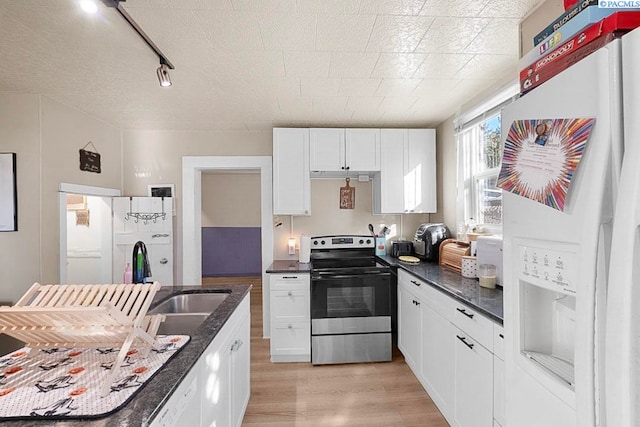 kitchen featuring sink, white cabinetry, stainless steel range with electric stovetop, white refrigerator with ice dispenser, and light hardwood / wood-style floors