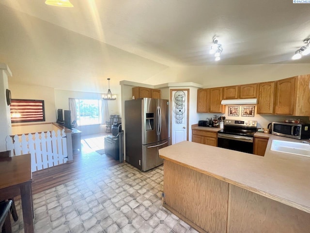 5019 Cambridge Ln, Pasco, WA 99301 - kitchen with stainless steel appliances, lofted ceiling, under cabinet range hood, light countertops, and a peninsula