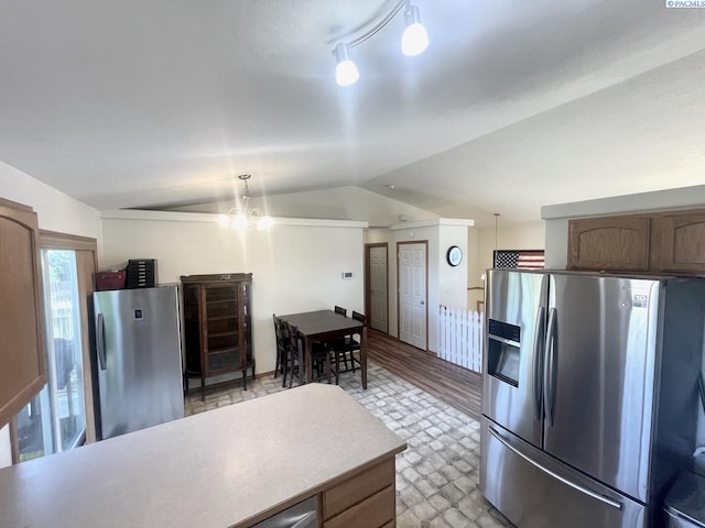 5019 Cambridge Ln, Pasco, WA 99301 - kitchen featuring stainless steel refrigerator with ice dispenser, freestanding refrigerator, vaulted ceiling, light countertops, and a chandelier