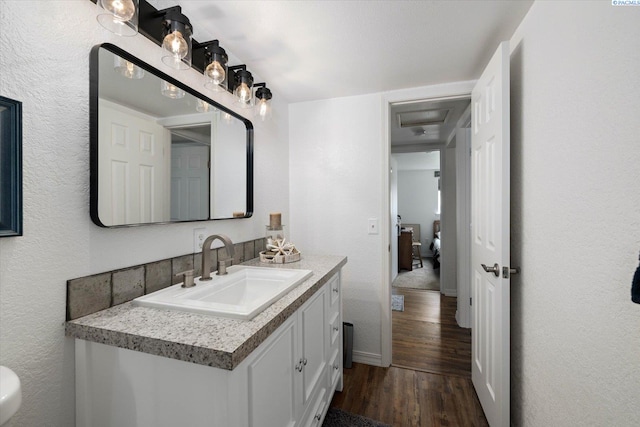 518 Wright Ave, Richland, WA 99352 - bathroom with wood finished floors, vanity, and baseboards