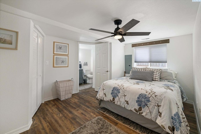 518 Wright Ave, Richland, WA 99352 - bedroom with wood finished floors, baseboards, ensuite bath, and ceiling fan