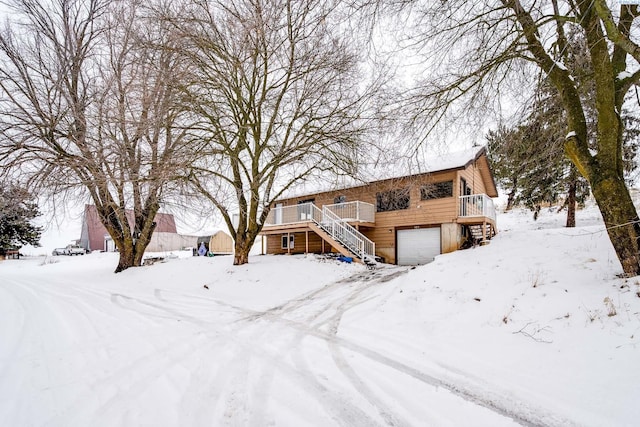 view of front of house featuring a garage and a deck