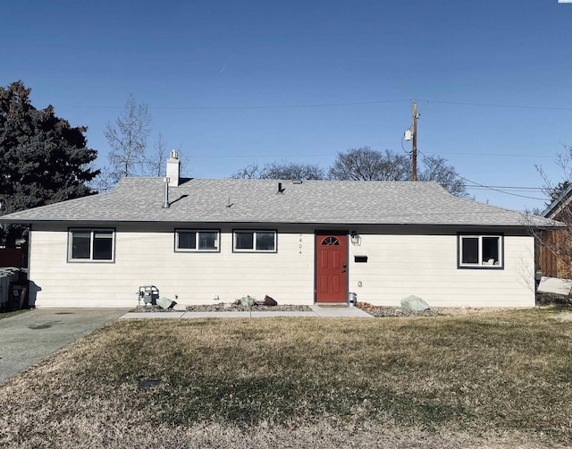 ranch-style home with a front lawn