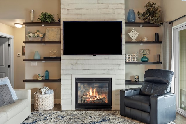 living room featuring hardwood / wood-style floors and built in shelves