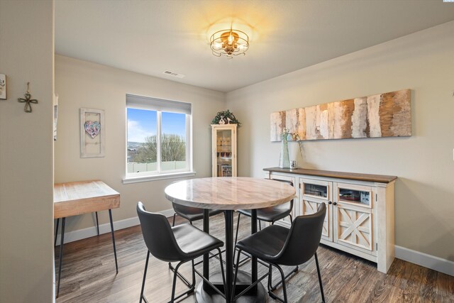 dining area with dark hardwood / wood-style flooring