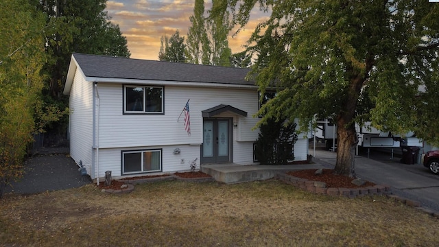 raised ranch featuring a yard