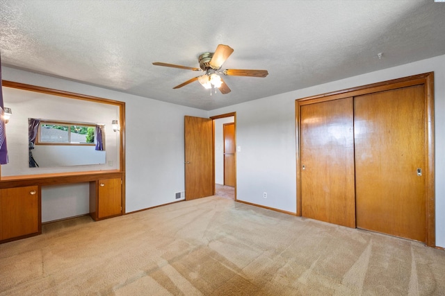 508 W Concord Ave, Grandview, WA 98930 - unfurnished bedroom featuring carpet floors, a closet, a textured ceiling, and ceiling fan