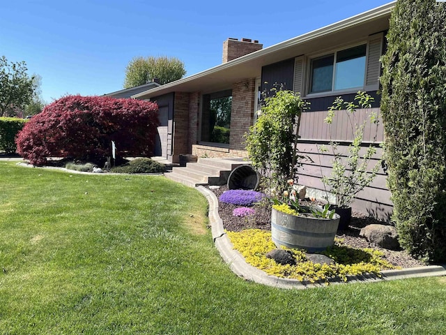508 W Concord Ave, Grandview, WA 98930 - view of home's exterior with a chimney and a lawn