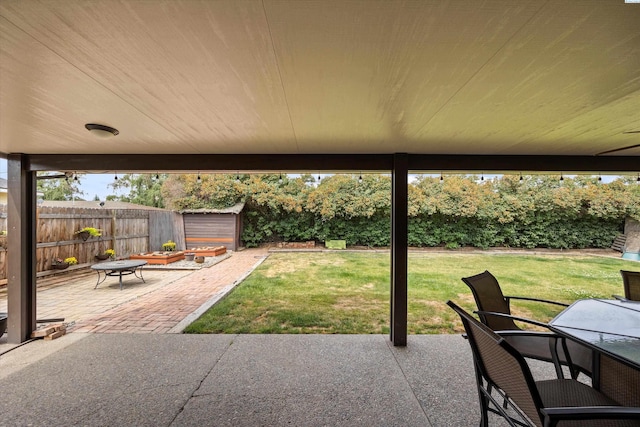 508 W Concord Ave, Grandview, WA 98930 - fenced backyard with a patio, a storage unit, and outdoor dining space