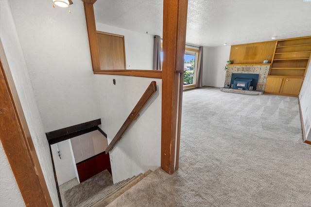 508 W Concord Ave, Grandview, WA 98930 - stairs with carpet, a fireplace, and a textured ceiling
