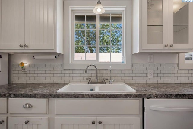 3700 Sheller Rd, Sunnyside, WA 98944 - kitchen with dishwasher, a sink, dark countertops, and white cabinetry