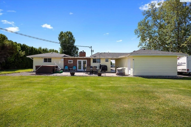 3700 Sheller Rd, Sunnyside, WA 98944 - back of house with french doors, a patio, a covered hot tub, and a lawn