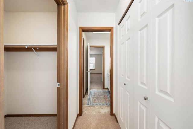 hall with light carpet and baseboards