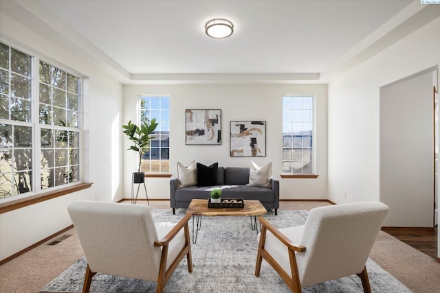 living room with visible vents, plenty of natural light, and baseboards