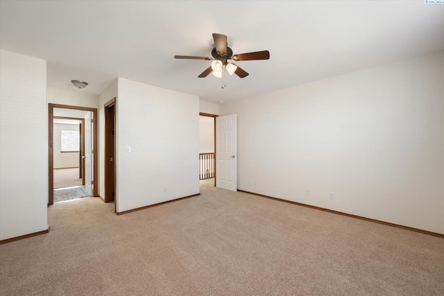 unfurnished bedroom with light carpet, baseboards, and a ceiling fan