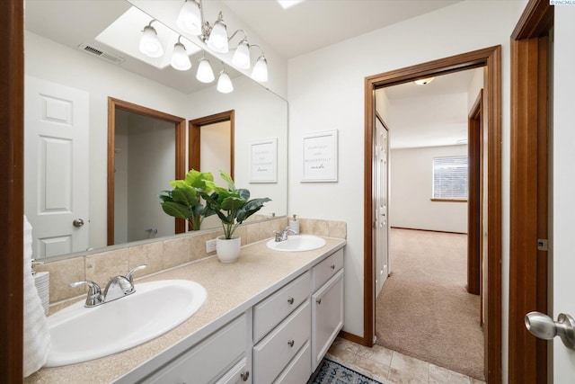 bathroom featuring double vanity, a sink, and visible vents