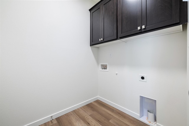 clothes washing area with light wood-style flooring, baseboards, washer hookup, cabinet space, and electric dryer hookup