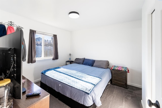 bedroom featuring dark carpet